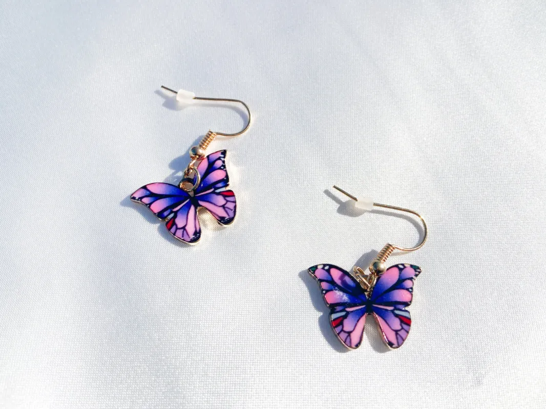 purple butterfly earrings sold by Sunkissed Coconut