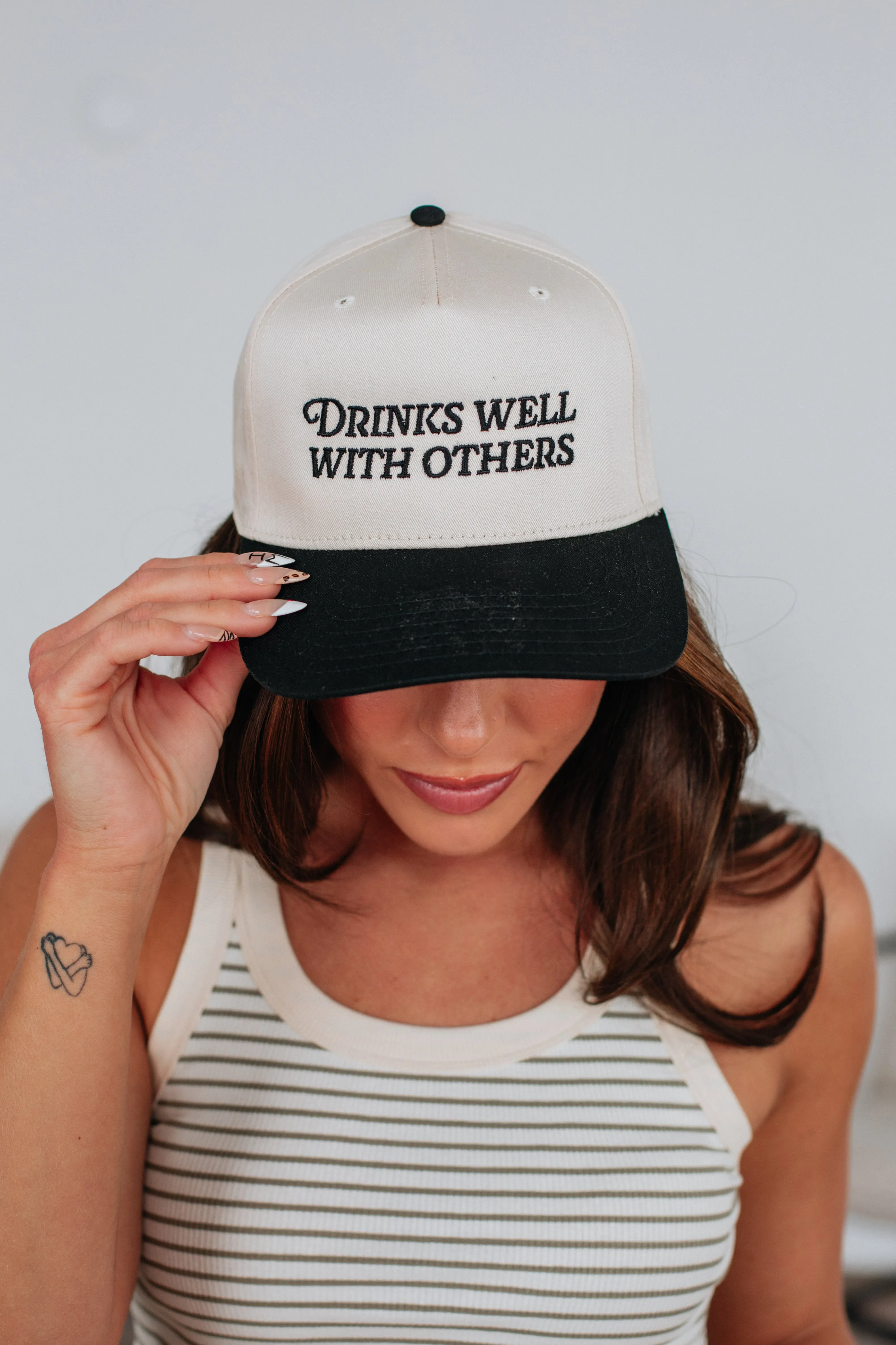 Drinks Well With Others Trucker Hat sold by Wild Oak Boutique