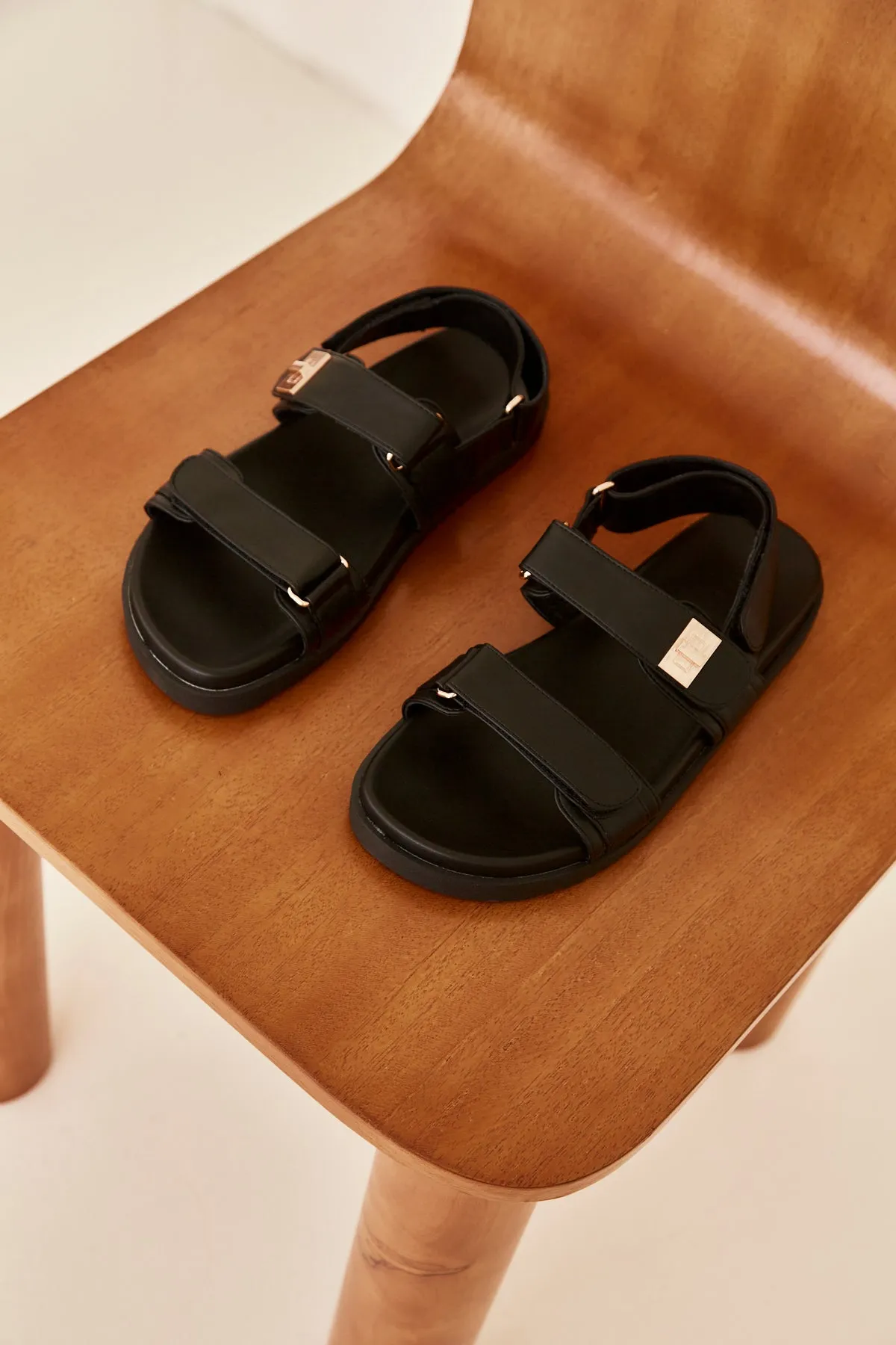 Alvina Sandal (Black) sold by Runway Scout