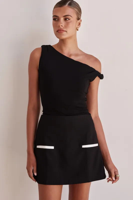 Maya Mini Skort (Black) sold by Runway Scout