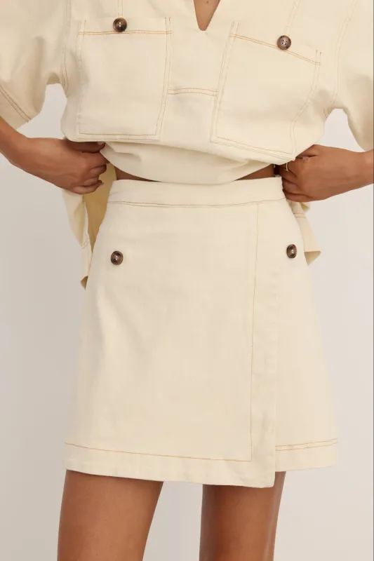 Amara Mini Skirt (Cream) sold by Runway Scout