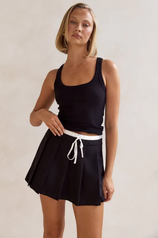 Jacqueline Mini Skort (Black) sold by Runway Scout