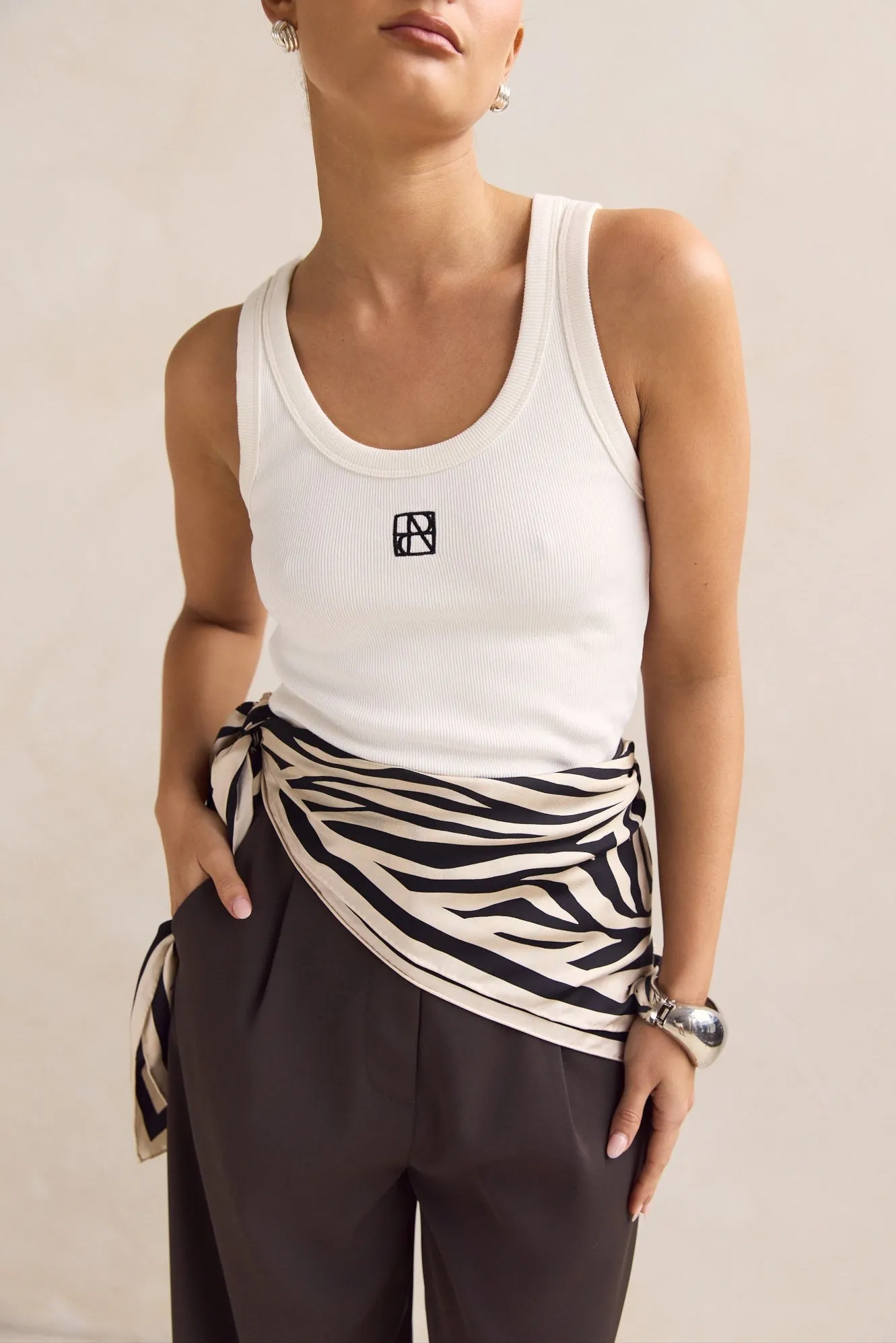 Lexi Signature Tank (White) sold by Runway Scout