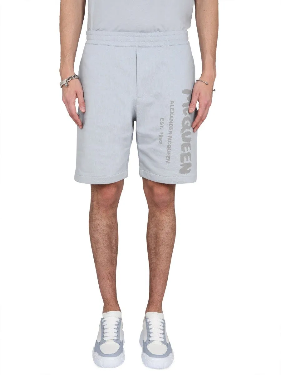 Alexander Mcqueen BERMUDA SHORTS WITH GRAFFITI LOGO PRINT sold by Siebentaschen