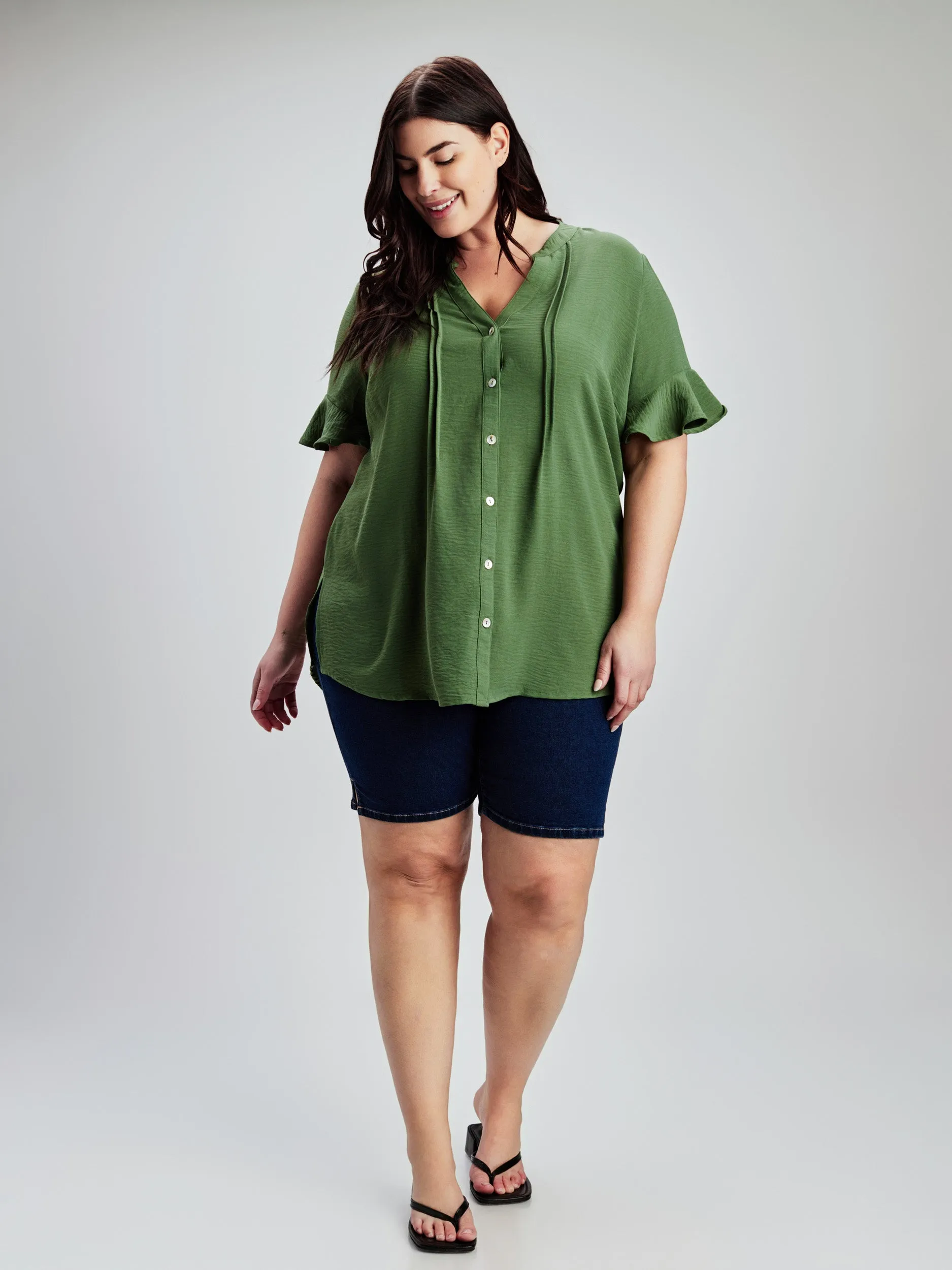 Short-sleeve semi-fitted blouse with buttons sold by Claire France