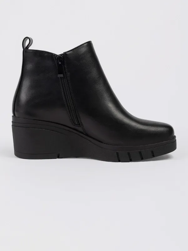 Boots with wedge heels sold by Claire France