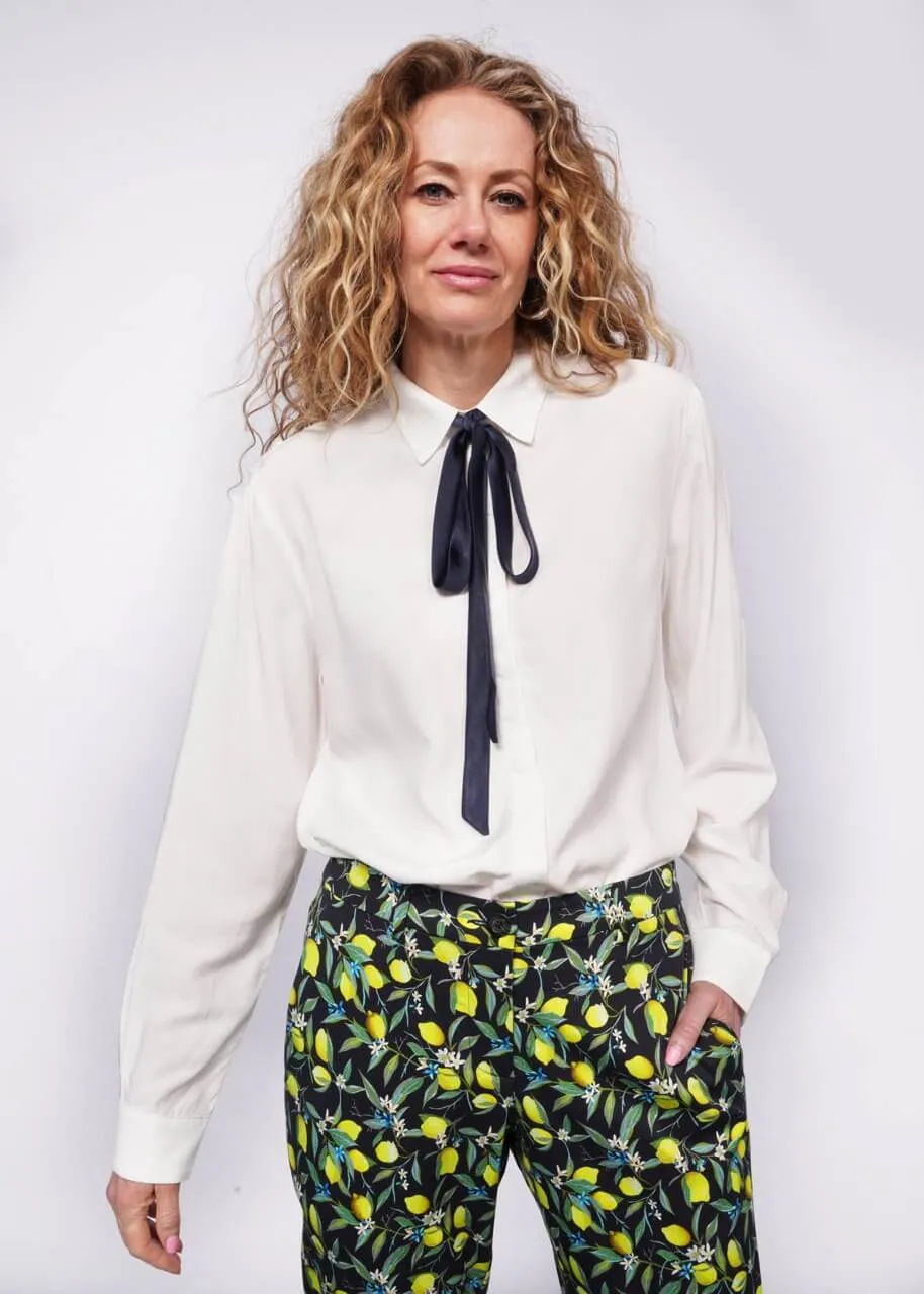 The Empower Long Sleeve Bow Button Up sold by WILDFANG