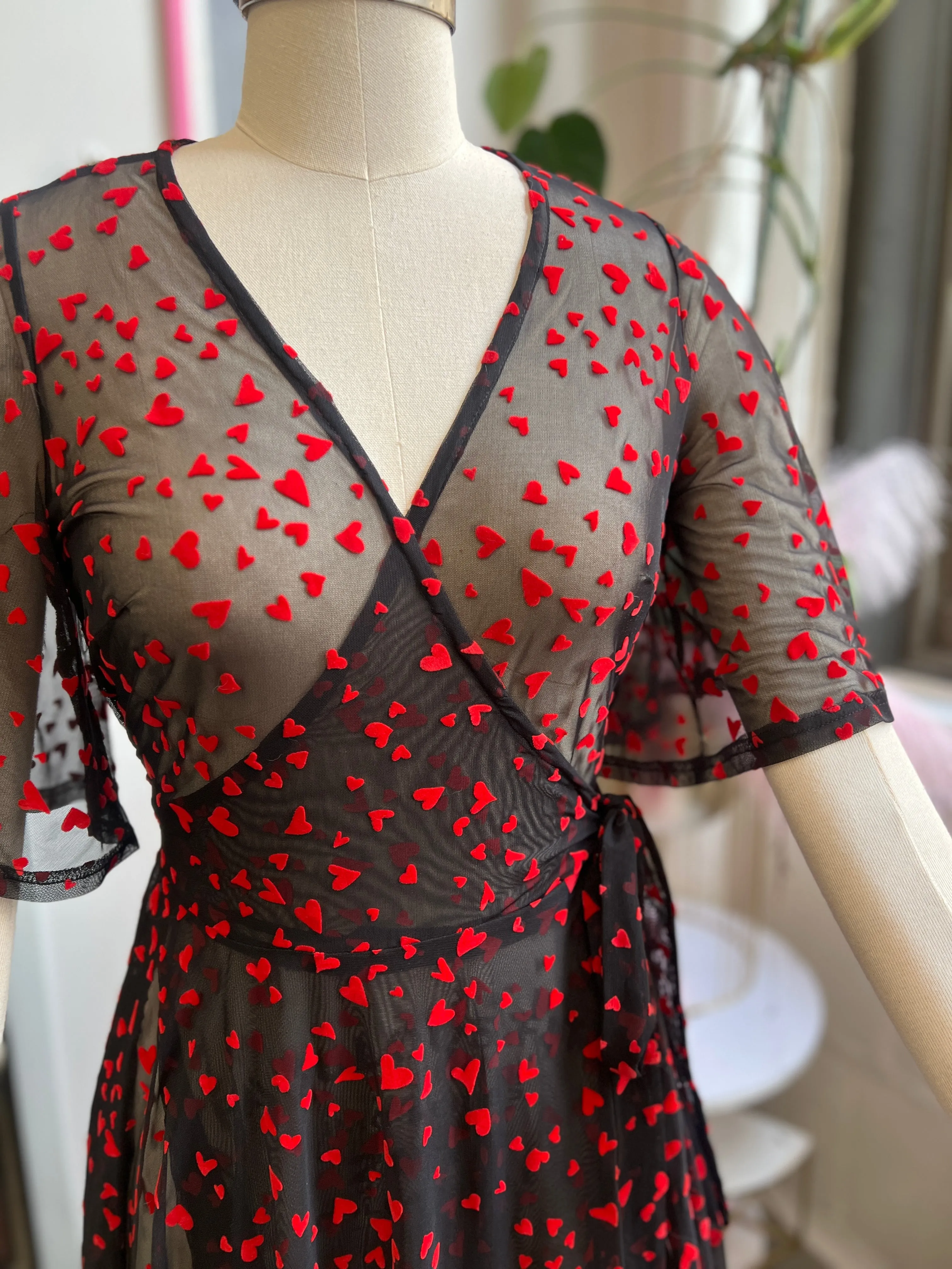 Lydia Wrap Dress in Black Queen of Hearts flocked mesh sold by Wax Poetic