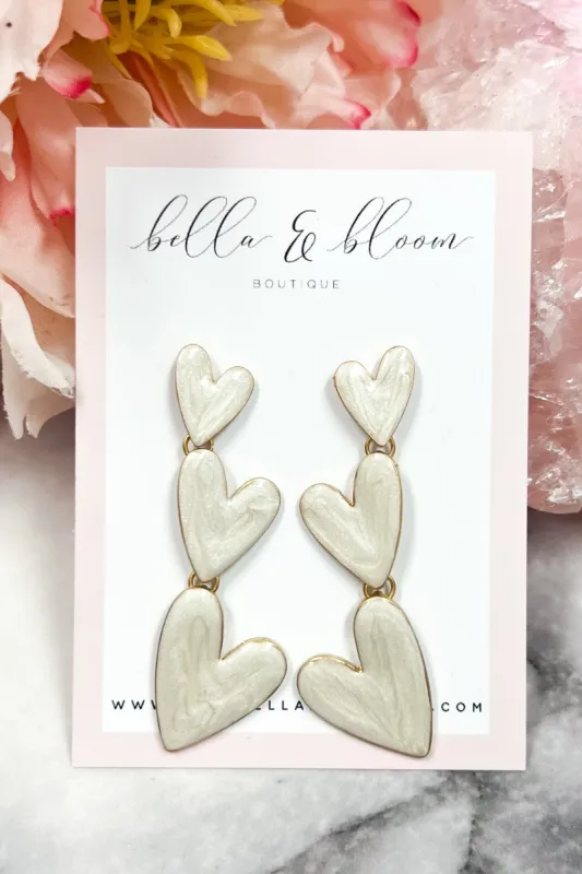 Love You More Tri-Heart Earrings: White sold by Bella and Bloom