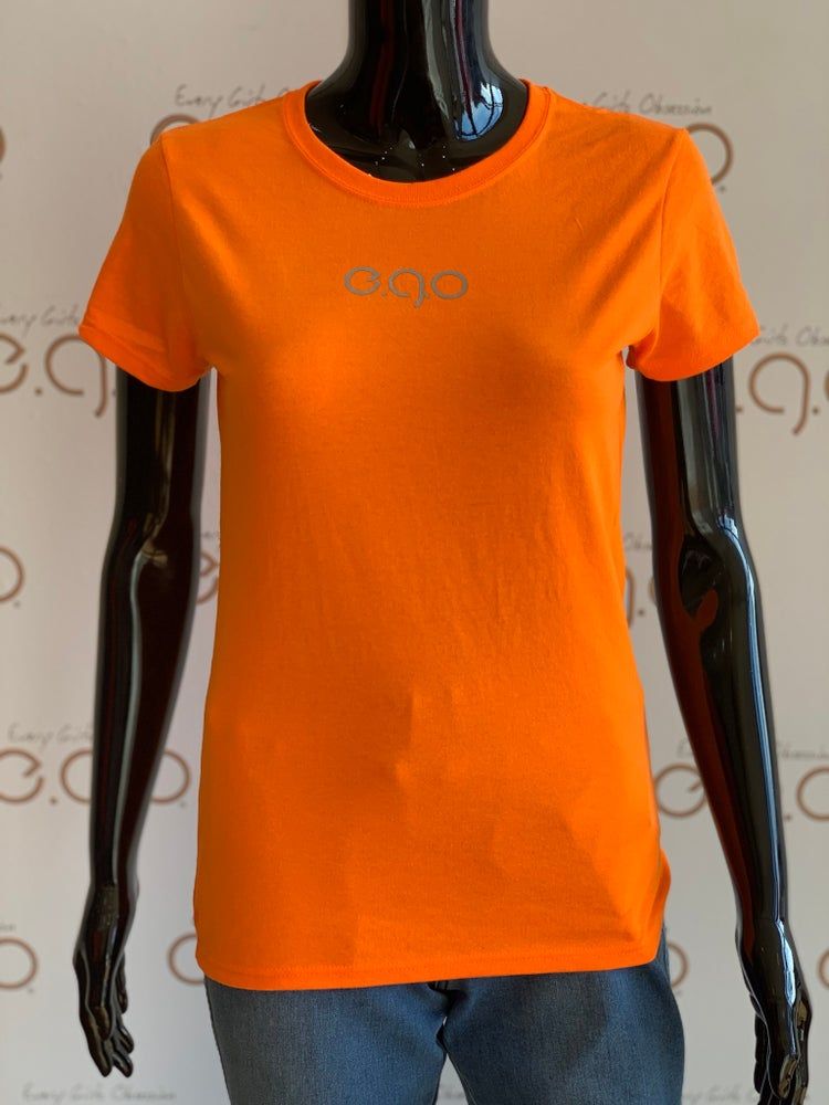 Orange reflective tee sold by Every Girl's Obsession