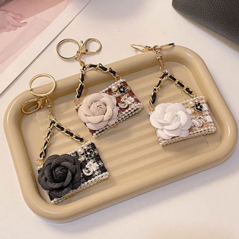 Metal Camellia Flower Mini Diamond Bag Shape Keychain sold by CRAVE by Frederick Wilhelm