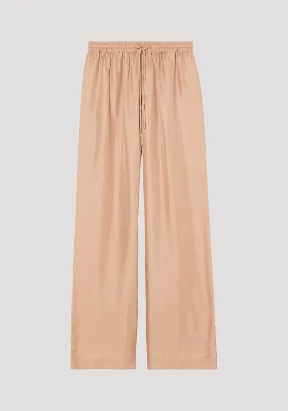 Wide leg silk trousers | powder sold by Rohe