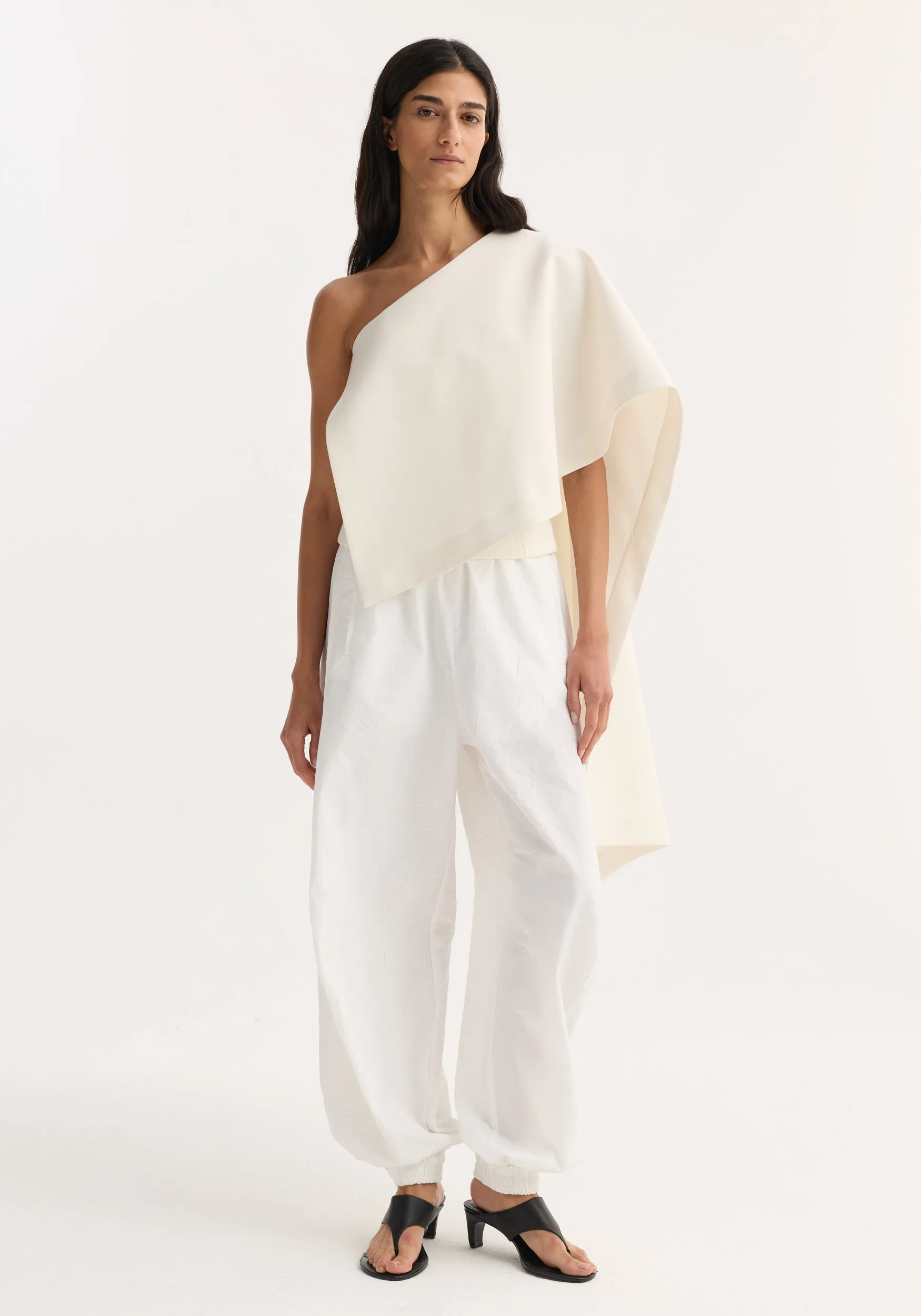 Draped cape top | cream sold by Rohe