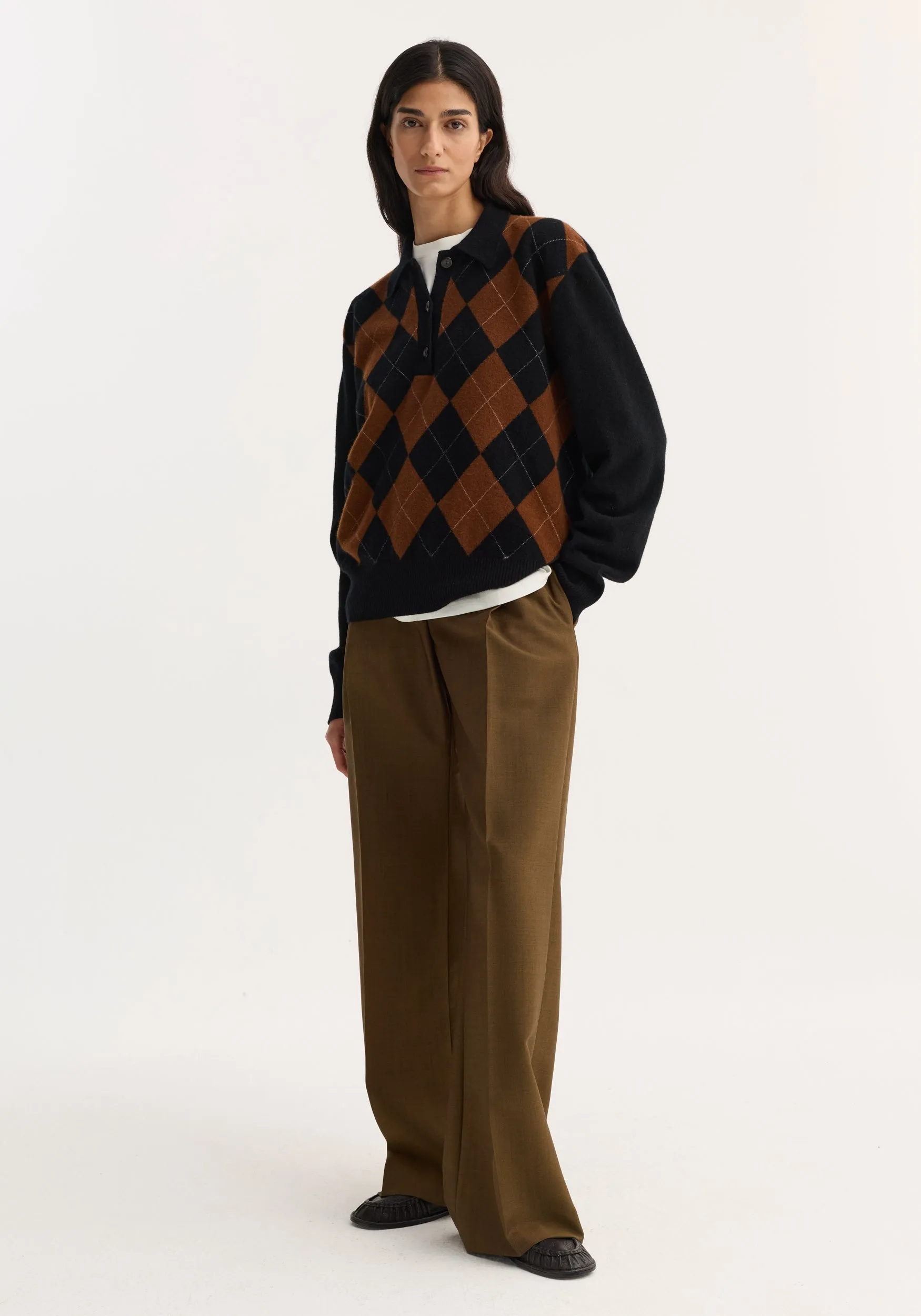 Compact knitted check polo | black rust check sold by Rohe
