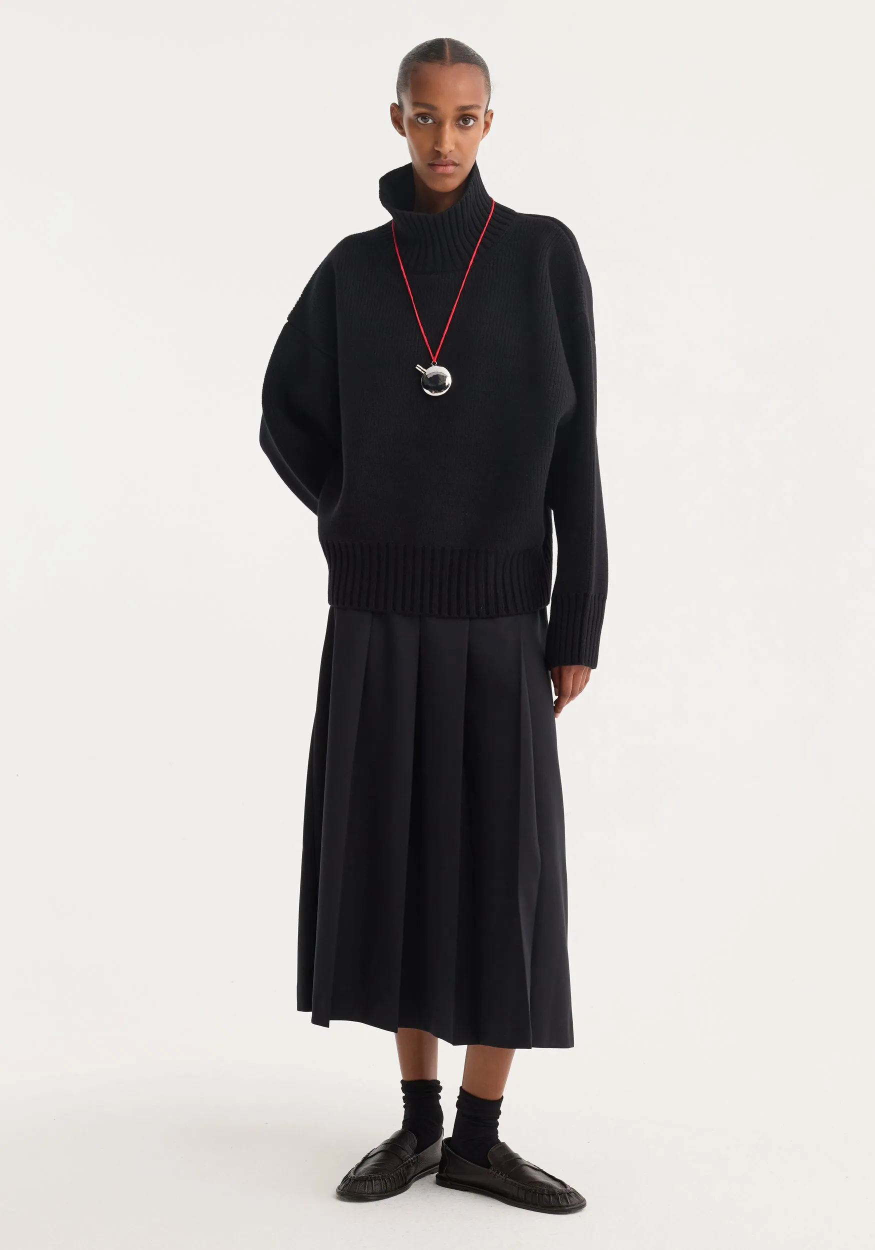 Sculptural compact turtleneck | black sold by Rohe