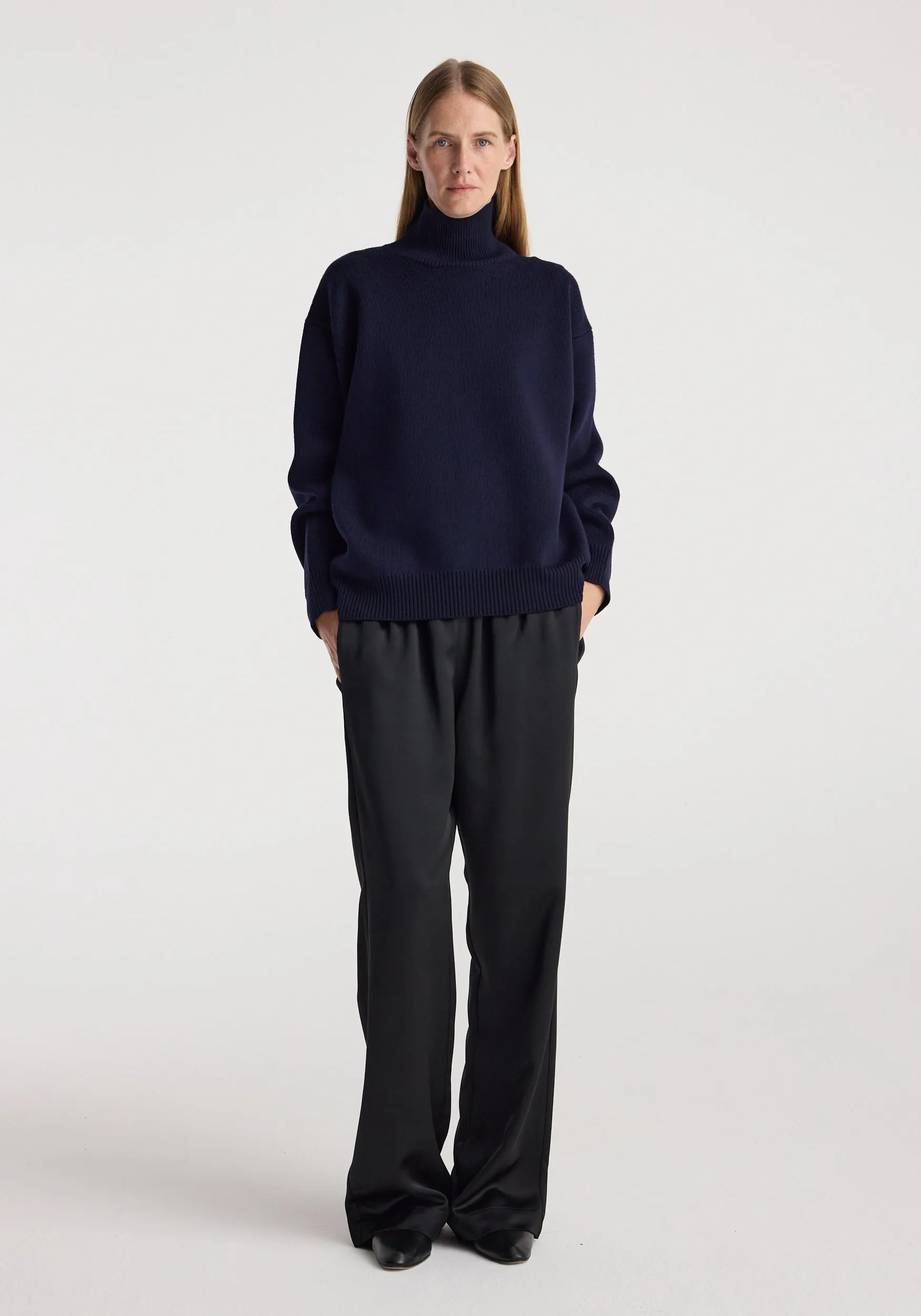 Sculptural compact turtleneck | navy sold by Rohe