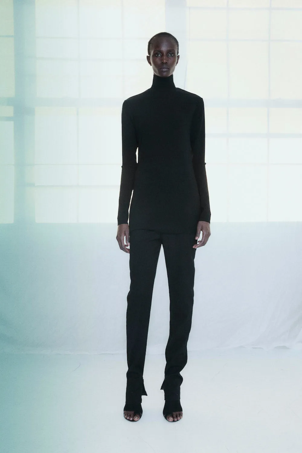 Long Sleeve Mockneck Tunic in Black sold by NOMIA