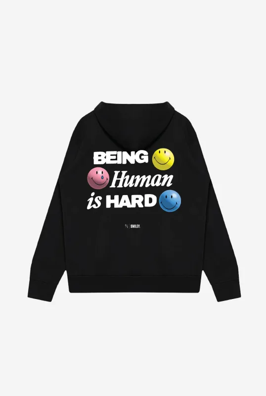 SMILEY: Being Human is Hard Heavyweight Hoodie - Black sold by Peace-Collective