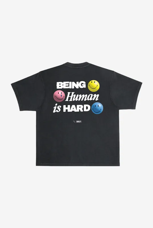 SMILEY: Being Human is Hard Heavyweight Garment Dyed T-Shirt - Black sold by Peace-Collective