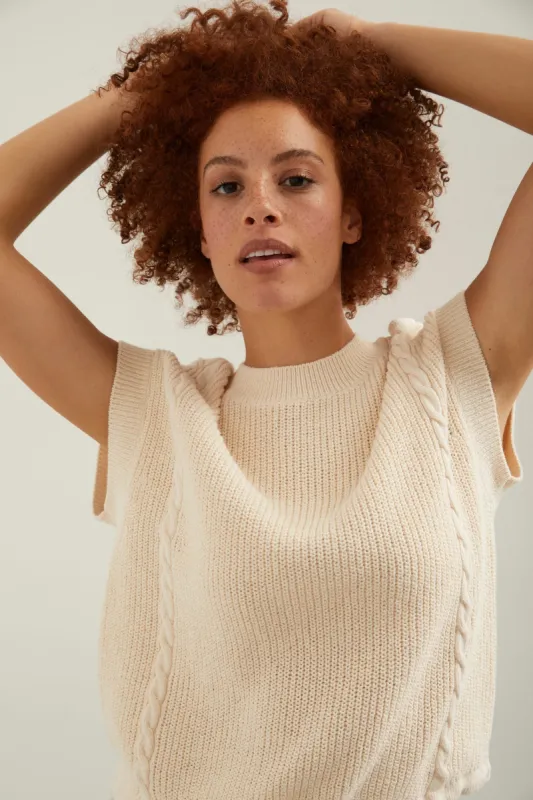 Sleeveless cable knit sweater sold by Tristan Style