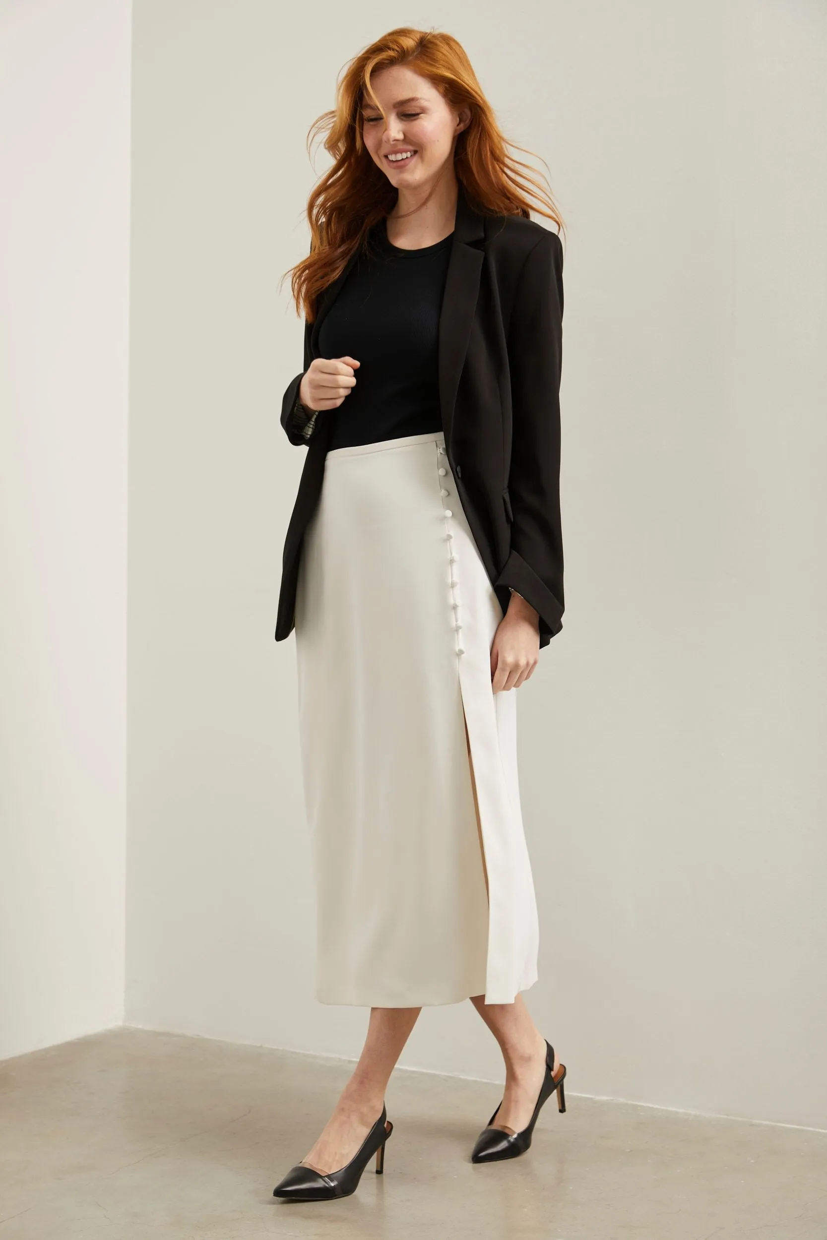Long flared skirt with front slit sold by Tristan Style