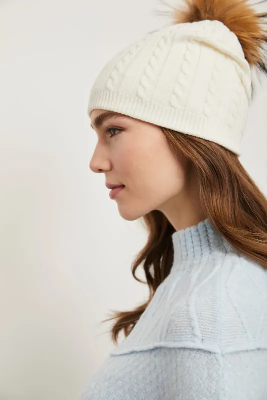 Hat with removable fur pompom sold by Tristan Style
