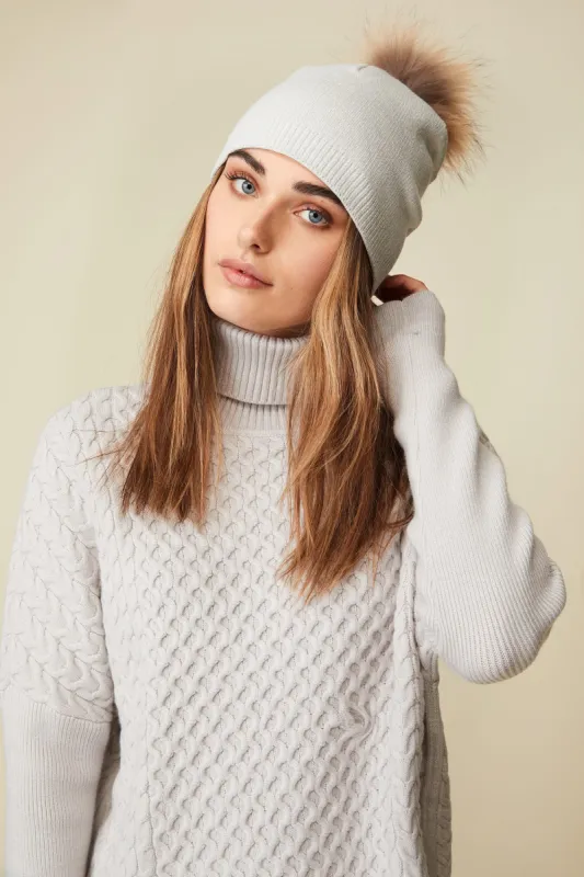 Metallic hat with removable fur pompom sold by Tristan Style