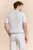 Cable-knit polo sold by Tristan Style