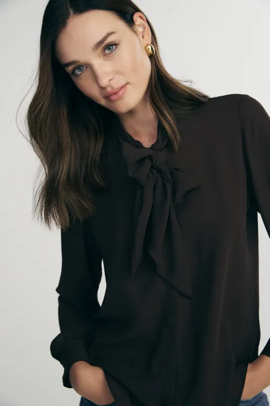 Button-down blouse with tied front sold by Tristan Style