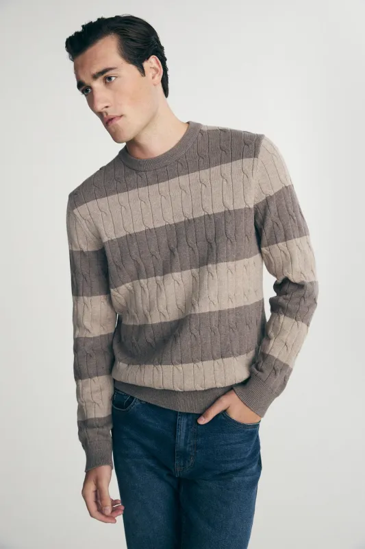 Striped cable-knit sweater sold by Tristan Style