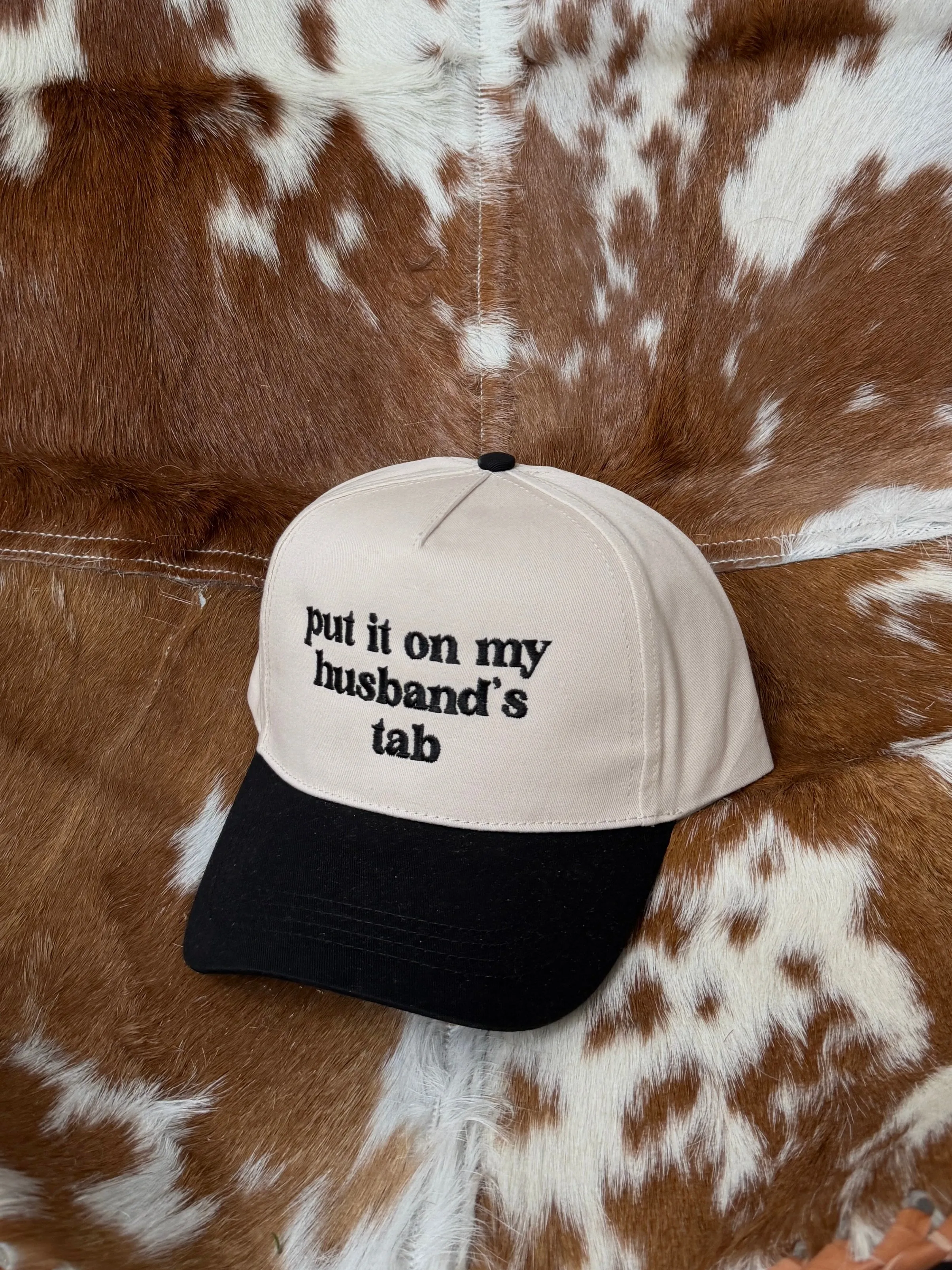 27 'Put It On My Husband's Tab' Embroidered Trucker Hat sold by 27 Boutique