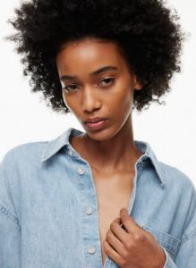 the 90s carla oversized denim shirt sold by Aritzia