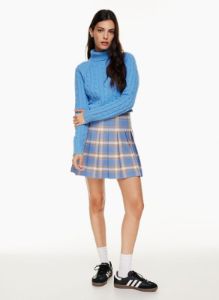 olive mini pleated skirt sold by Aritzia