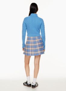olive mini pleated skirt sold by Aritzia