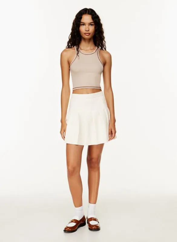 olive micro pleated skirt sold by Aritzia