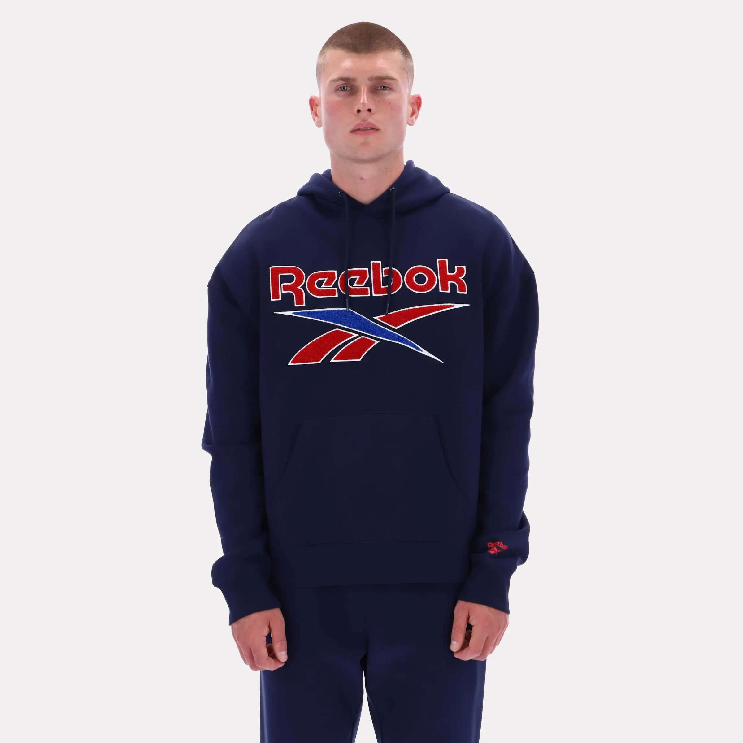 Reebok Apparel Men Reebok Varsity Graphic Hoodie VECTOR NAVY sold by Reebok