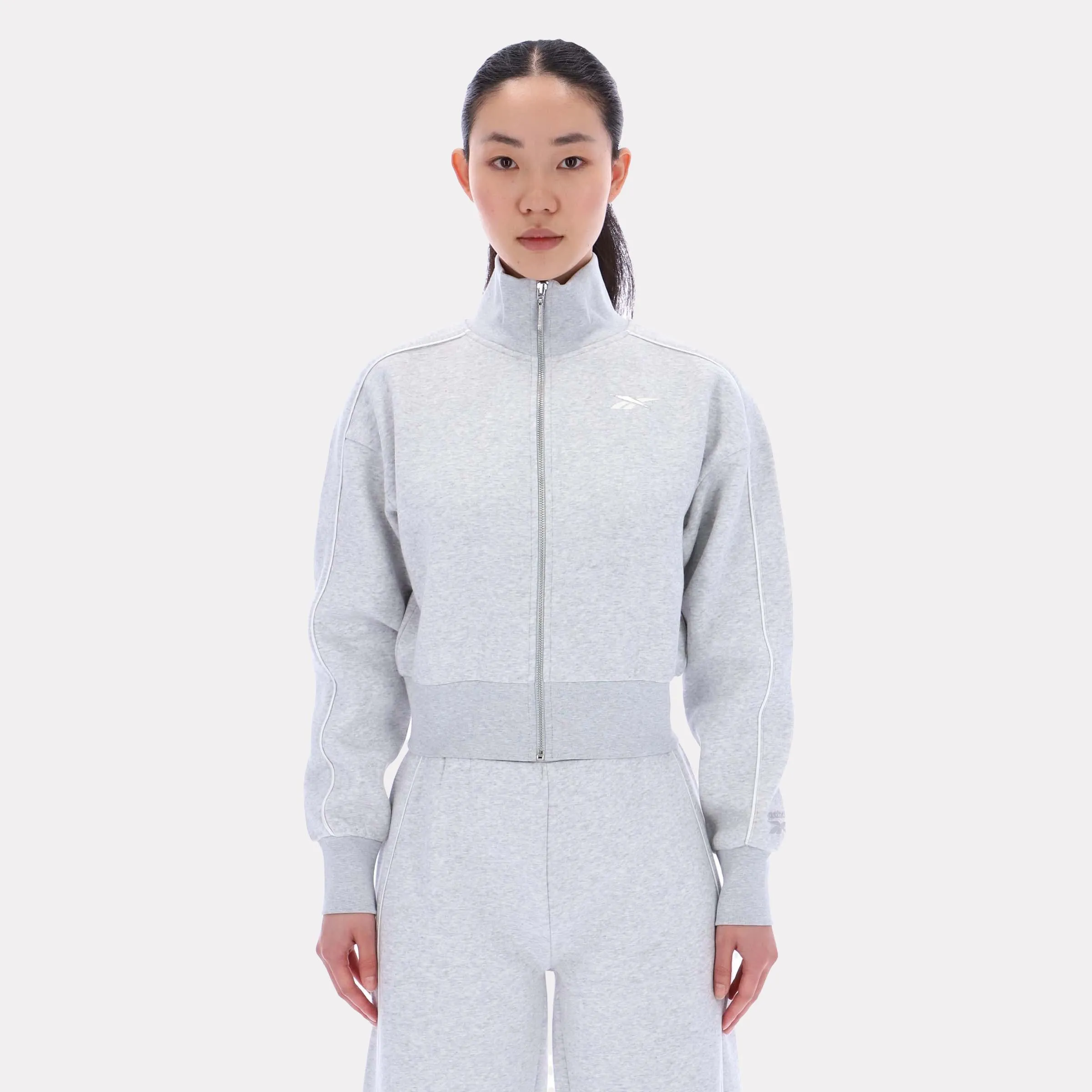 Reebok Apparel Women Off-Duty Cropped Jacket SILVER MARL sold by Reebok