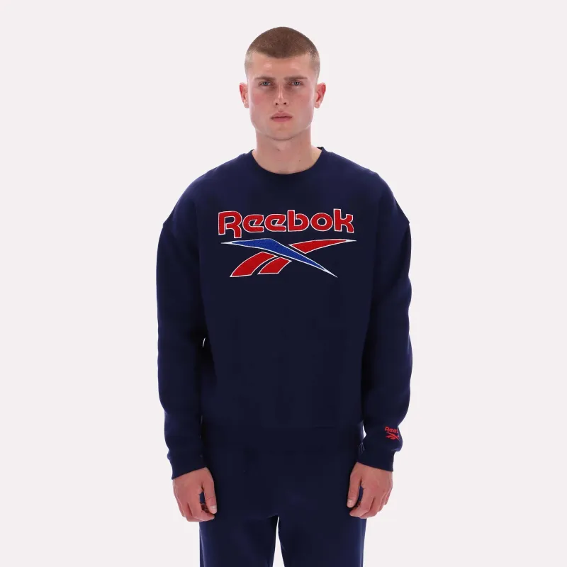 Reebok Apparel Men Varsity Graphic Sweatshirt VECTOR NAVY sold by Reebok