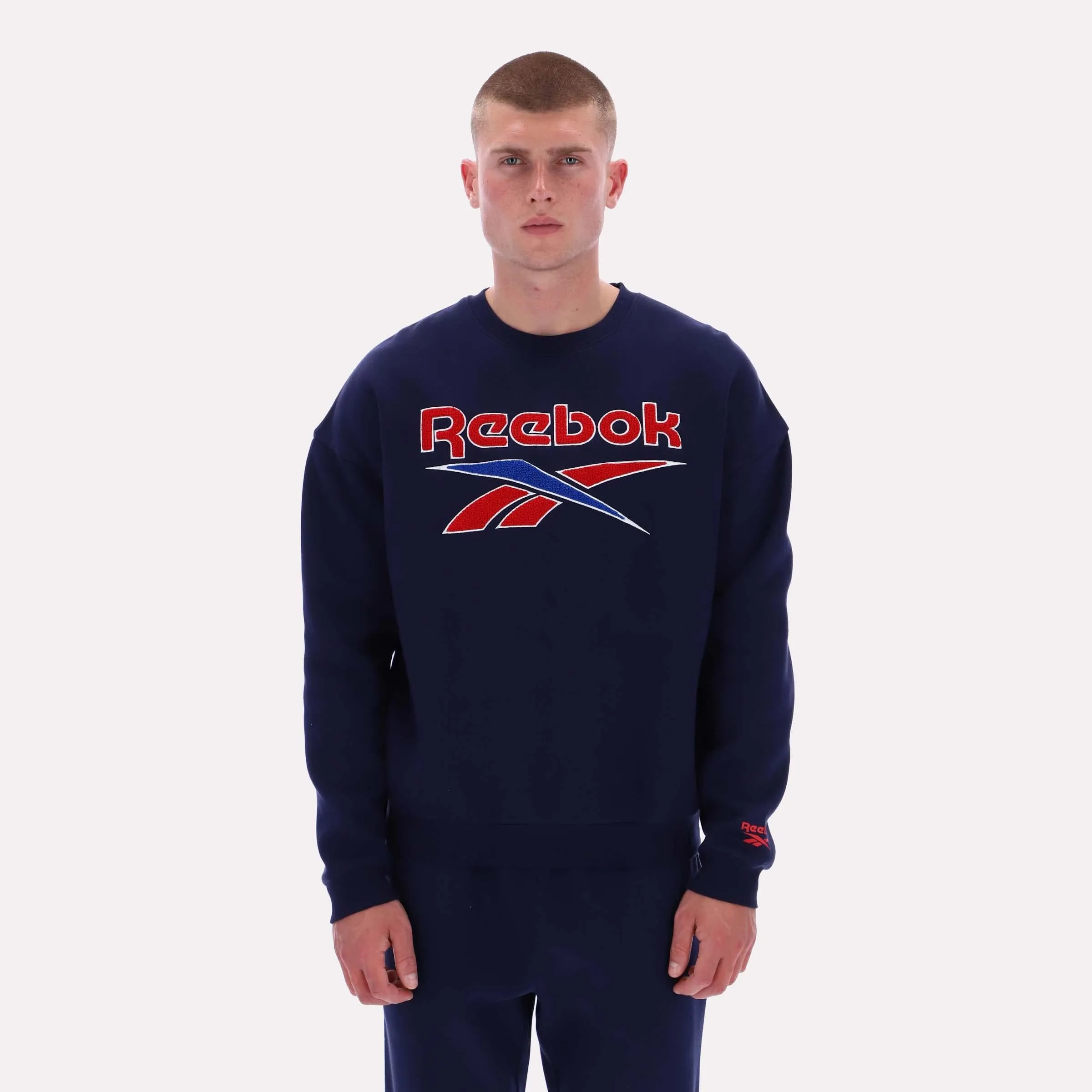 Reebok Apparel Men Varsity Graphic Sweatshirt VECTOR NAVY sold by Reebok