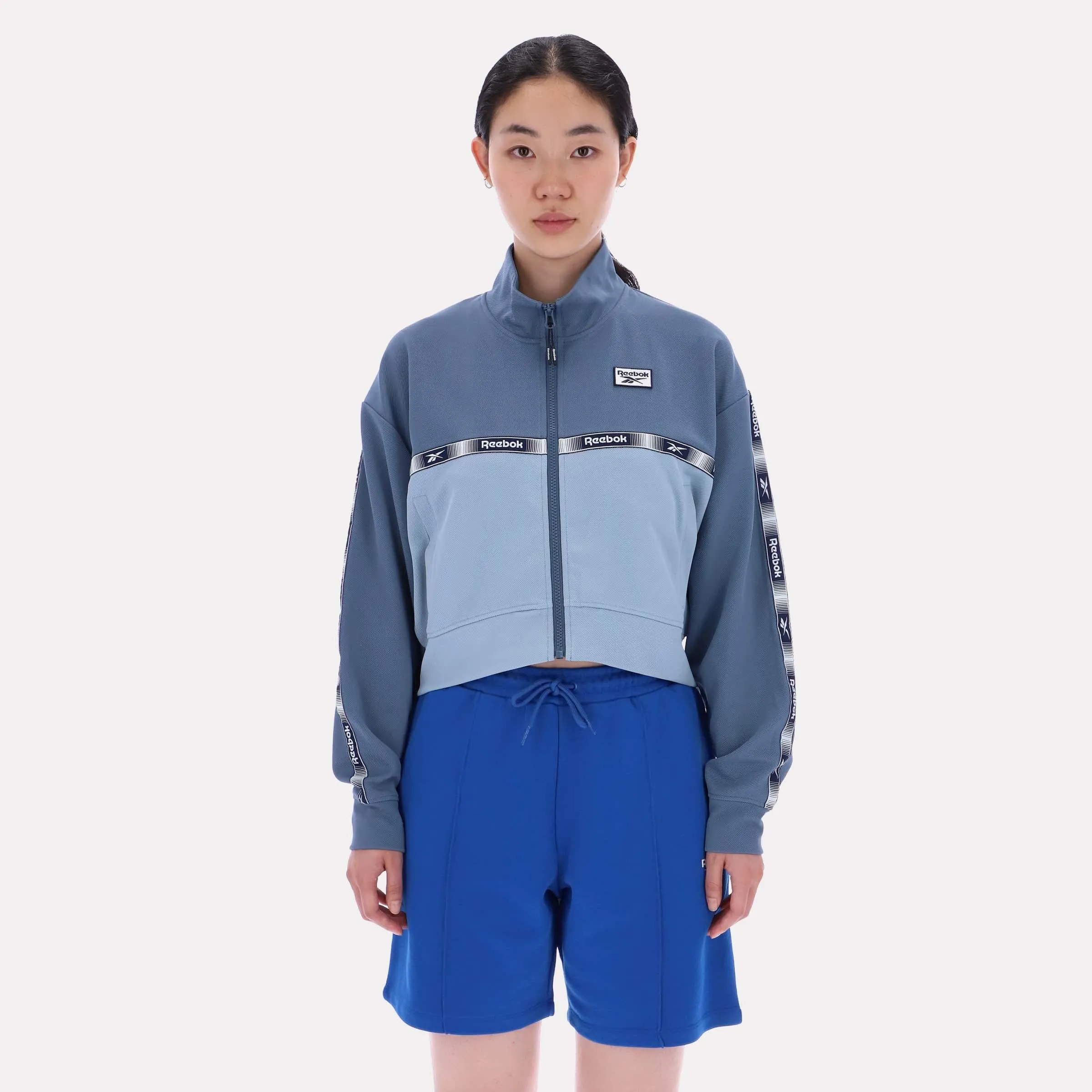 Reebok Apparel Women Cropped Vector Track Jacket LEISURE BLUE/SHADOW sold by Reebok