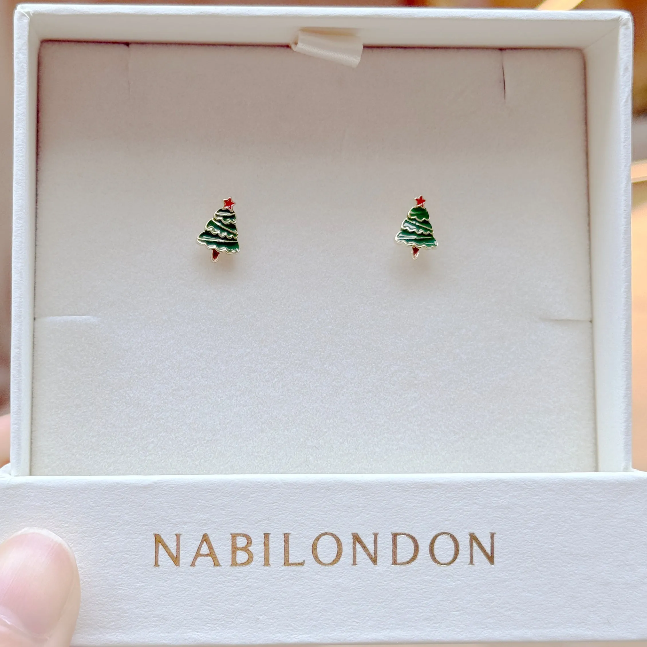Christmas tinsel tree earrings sold by NABI LONDON