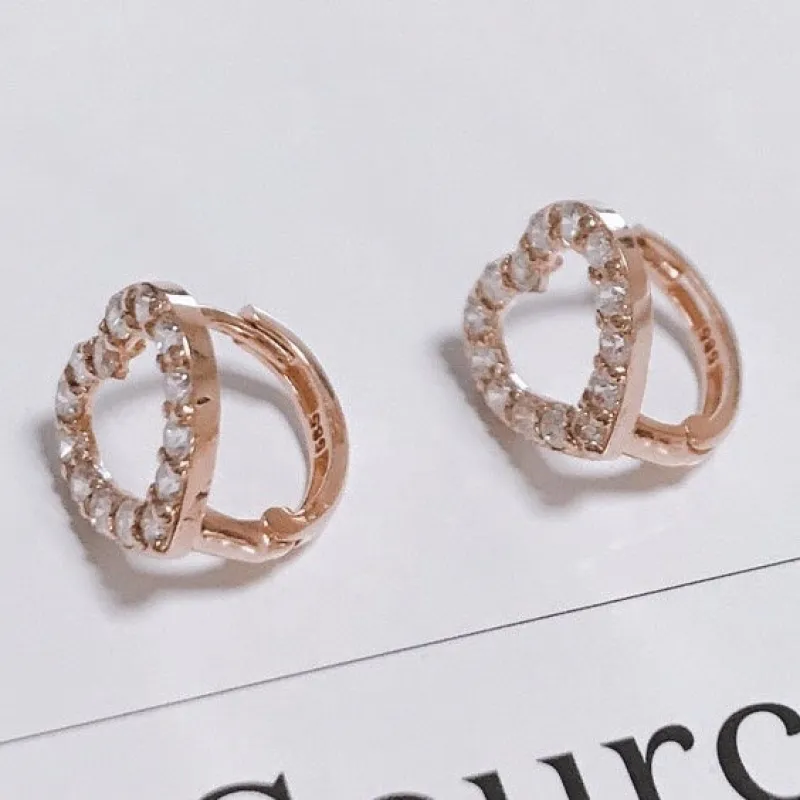 Cubic heart huggie earrings sold by NABI LONDON