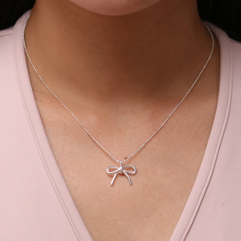 Bow pendant necklace sold by NABI LONDON