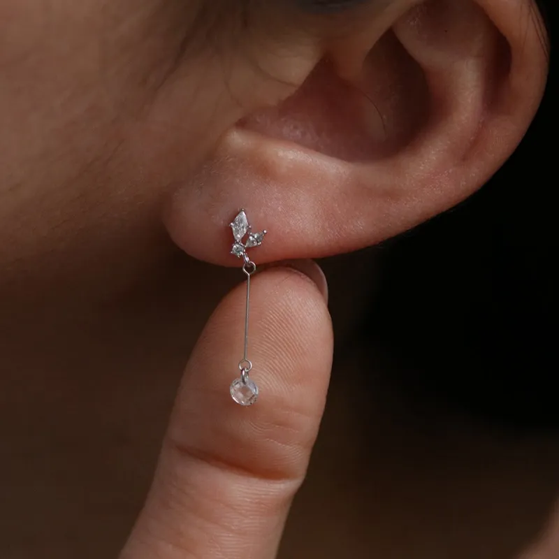 Cubic wing drop earrings sold by NABI LONDON