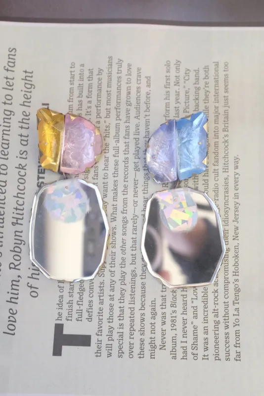 Nikki Couppee Mismatched Dangle Mirrored Earrings sold by Beklina