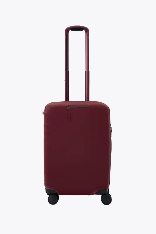 The Carry-On Luggage Cover in Burgundy sold by Beis