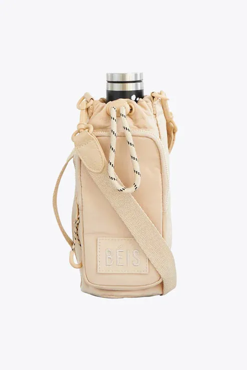 The Water Bottle Sling in Beige sold by Beis