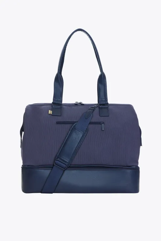 The Convertible Weekender in Navy sold by Beis