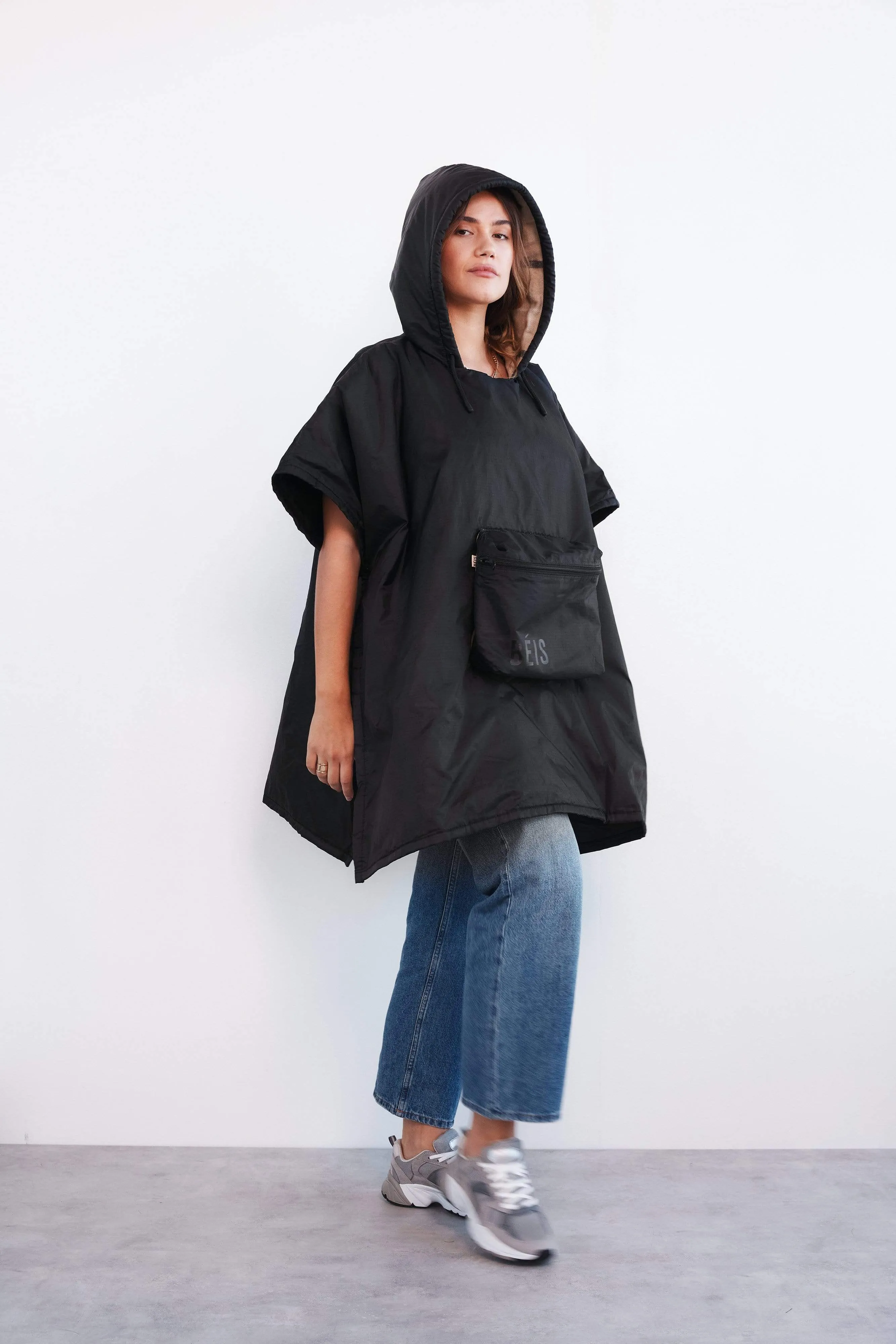 The Packable Poncho in Black sold by Beis