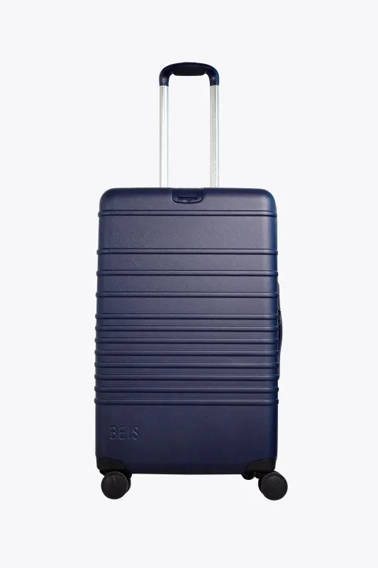 The Medium Check-In Roller in Navy made by Beis